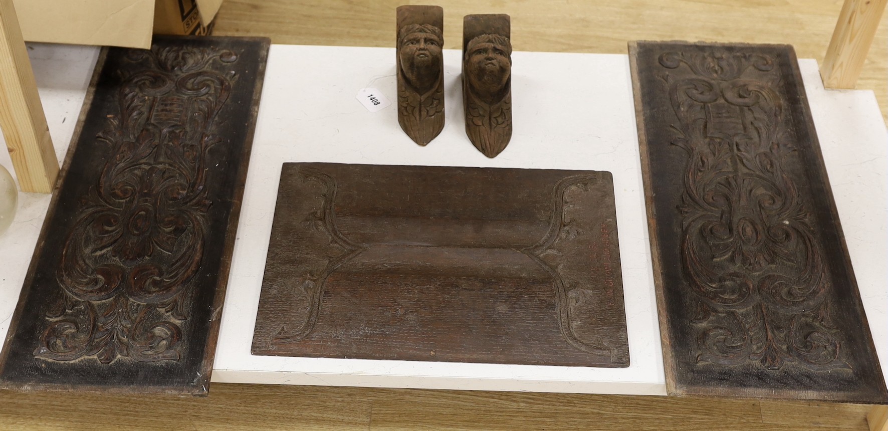 Three carved oak panels and a pair of brackets, one linenfold oak panel carved ‘from Crowland Abbey’, 46 cm X 33 cm